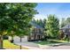 Attractive two-story brick home with a two-car garage, lush greenery, and a well-maintained lawn at 1496 Clarecastle Ln, Buford, GA 30519