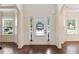 Bright foyer with hardwood floors, wainscoting, and large windows, offering an inviting entrance at 1496 Clarecastle Ln, Buford, GA 30519