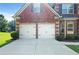 Close-up of a two-car garage, showing the brick facade and the well-maintained exterior of the home at 1496 Clarecastle Ln, Buford, GA 30519