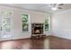 Living room featuring a stone fireplace, hardwood floors, and natural light at 1496 Clarecastle Ln, Buford, GA 30519