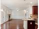 Spacious living area with hardwood floors, a stone fireplace, and an open floor plan at 1496 Clarecastle Ln, Buford, GA 30519
