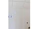 Bare wall with water hookups and a wire shelf at 1496 Clarecastle Ln, Buford, GA 30519