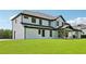 The house has a well-manicured lawn and a modern exterior with black trim and white paint at 3205 Bold Springs Rd, Dacula, GA 30019