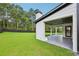 Beautiful backyard with lush green grass, bordered by a black fence and features a covered patio at 3205 Bold Springs Rd, Dacula, GA 30019