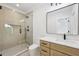 Modern bathroom featuring a glass shower, neutral tile, and light wood vanity with a white marble countertop at 3205 Bold Springs Rd, Dacula, GA 30019