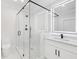 Modern bathroom featuring glass enclosed shower, marble tile, vanity and lighted mirror at 3205 Bold Springs Rd, Dacula, GA 30019
