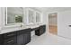 Bathroom boasts illuminated mirrors, dual vanity, and a glass shower, complemented by white tile flooring at 3205 Bold Springs Rd, Dacula, GA 30019