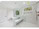 Bathroom features a freestanding tub, large glass shower with bench, and luxurious marble finishes at 3205 Bold Springs Rd, Dacula, GA 30019