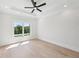 Bright bedroom featuring hardwood floors, recessed lighting, and a large window at 3205 Bold Springs Rd, Dacula, GA 30019