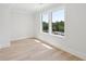 Bright bedroom with natural light and hardwood floors overlooking trees at 3205 Bold Springs Rd, Dacula, GA 30019
