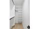 Walk-in closet with wood floor and white shelving at 3205 Bold Springs Rd, Dacula, GA 30019
