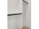 Close-up of a modern closet showcasing white walls, black rods, and ample storage space at 3205 Bold Springs Rd, Dacula, GA 30019