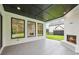 Outdoor covered patio features a brick fireplace, dark-stained wood ceiling, and a view of the lush backyard at 3205 Bold Springs Rd, Dacula, GA 30019