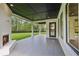 Covered patio features a brick fireplace, dark stained wood ceiling, gray-tiled floor, and access to the backyard at 3205 Bold Springs Rd, Dacula, GA 30019