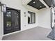 Close-up of the front entrance featuring decorative double doors, recessed lighting, and tiled porch at 3205 Bold Springs Rd, Dacula, GA 30019