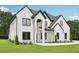 Handsome two-story house showcasing painted brick, black trim, an arched entrance, and a lush green lawn at 3205 Bold Springs Rd, Dacula, GA 30019