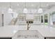 Close up of a kitchen island with a farmhouse sink and modern fixtures at 3205 Bold Springs Rd, Dacula, GA 30019