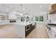 Bright, open kitchen featuring a large island, modern appliances, and hardwood floors at 3205 Bold Springs Rd, Dacula, GA 30019