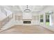 Bright living room boasting hardwood floors, built-in shelves, a fireplace, and large windows overlooking the yard at 3205 Bold Springs Rd, Dacula, GA 30019