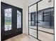 Stylish office with a glass-panel door, built-in shelves, cabinets, and light wood floors at 3205 Bold Springs Rd, Dacula, GA 30019