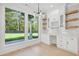 Well-lit home office featuring custom cabinetry and a large window overlooking the backyard at 3205 Bold Springs Rd, Dacula, GA 30019