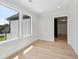 Bright room with large windows, light hardwood floors, and white trim creating an open, airy feel at 3205 Bold Springs Rd, Dacula, GA 30019