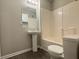 Bathroom featuring pedestal sink, modern lighting, and a tub/shower at 4044 Robin Cir, Atlanta, GA 30349