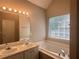 Bathroom with double vanity, soaking tub, and neutral wall color at 4044 Robin Cir, Atlanta, GA 30349