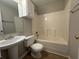 Bathroom with a tub/shower combo and a pedestal sink at 4044 Robin Cir, Atlanta, GA 30349