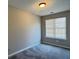 Neutral bedroom with large window and plush gray carpet at 4044 Robin Cir, Atlanta, GA 30349