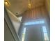 Bright entryway with high ceilings, decorative light, and staircase at 4044 Robin Cir, Atlanta, GA 30349