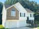 Charming two-story home with a stone facade and attached two-car garage at 4044 Robin Cir, Atlanta, GA 30349