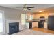 Open-concept kitchen and living area with a fireplace and sleek black appliances at 4044 Robin Cir, Atlanta, GA 30349