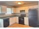 Functional kitchen featuring white cabinets, a black refrigerator, and essential appliances at 4044 Robin Cir, Atlanta, GA 30349
