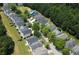 A picturesque aerial view showcases the neighborhood's peaceful residential street surrounded by mature trees and well-maintained landscaping at 646 Lakes Cir, Lithonia, GA 30058