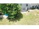 Spacious backyard featuring a patio, mature trees, and a lush lawn for outdoor enjoyment at 646 Lakes Cir, Lithonia, GA 30058