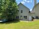 Spacious backyard with lush lawn, patio, and a view of the home's exterior at 646 Lakes Cir, Lithonia, GA 30058