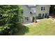 Backyard with a lawn, patio, trees, and fence provides ample space for outdoor activities at 646 Lakes Cir, Lithonia, GA 30058