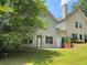 Spacious backyard with lush lawn, patio, and a view of the home's exterior at 646 Lakes Cir, Lithonia, GA 30058