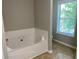 This bathroom includes a white bathtub and window at 646 Lakes Cir, Lithonia, GA 30058