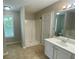 Bright bathroom with white vanity, shower, separate tub, and tile flooring at 646 Lakes Cir, Lithonia, GA 30058