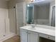 Bright bathroom with white vanity, shower, separate tub, and tile flooring at 646 Lakes Cir, Lithonia, GA 30058