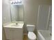 This bathroom features a single sink vanity, toilet, mirror, and a tub at 646 Lakes Cir, Lithonia, GA 30058