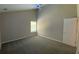 Bright bedroom features neutral walls, carpet flooring, a window and a door at 646 Lakes Cir, Lithonia, GA 30058
