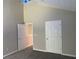 Bedroom with neutral walls, carpet flooring, and a view of two doors at 646 Lakes Cir, Lithonia, GA 30058