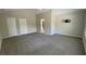 This spacious bedroom features vaulted ceilings, neutral paint, gray carpet, and two doors at 646 Lakes Cir, Lithonia, GA 30058