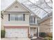 Charming two-story home with brick accents and attached garage on a landscaped lot at 646 Lakes Cir, Lithonia, GA 30058