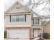 Charming two-story home with brick accents and attached garage on a landscaped lot at 646 Lakes Cir, Lithonia, GA 30058