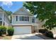 Charming two-story home with attached garage and nicely landscaped front yard at 646 Lakes Cir, Lithonia, GA 30058