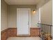 A covered front porch features brick accents and a secure entrance at 646 Lakes Cir, Lithonia, GA 30058